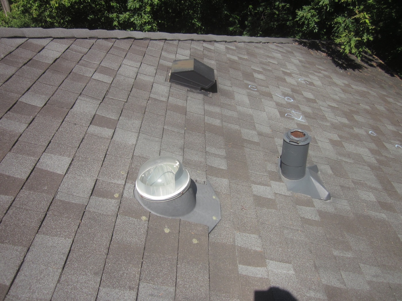 hail damage marked on asphalt roof