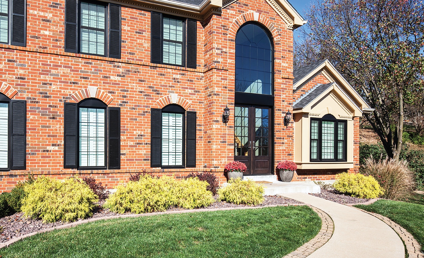  Infinity from Marvin Windows with Black Trim on a brick home