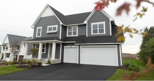 Traditional home with gorgeous blue vinyl siding installed by Lindus Construction