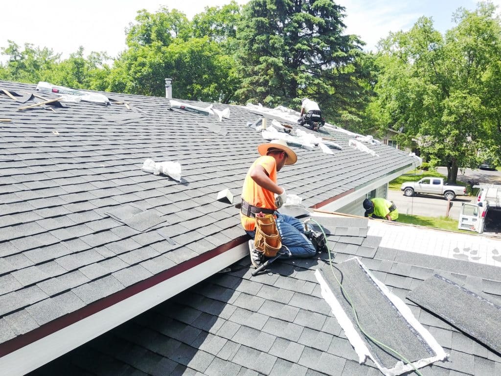 Lindus Construction roofing contractors installing asphalt shingles