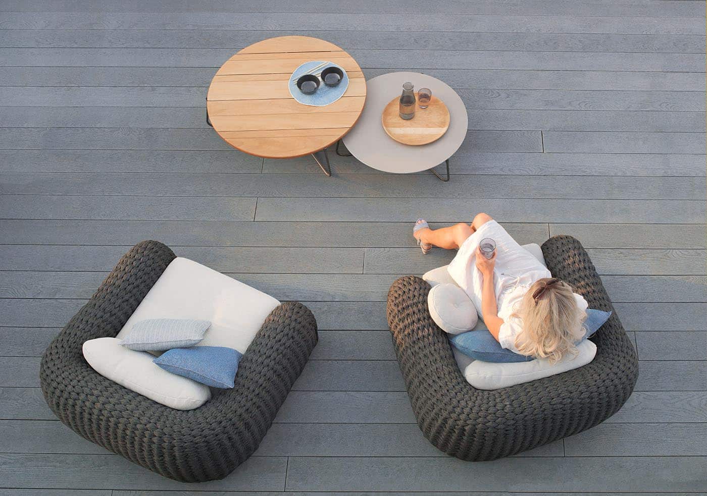 Woman sitting on a modern deck.